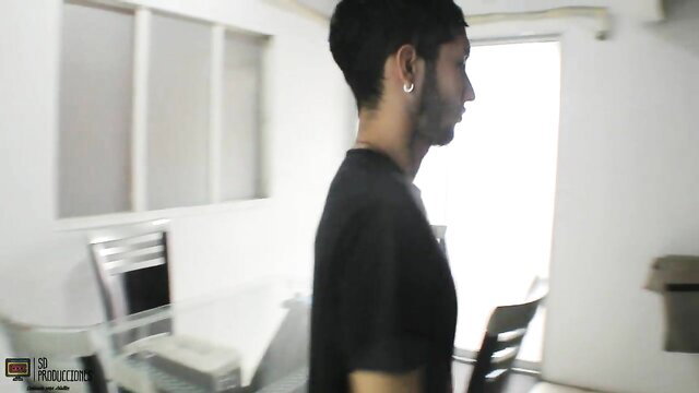 Arab stepbrother in tight black tee turns side profile in sunny room