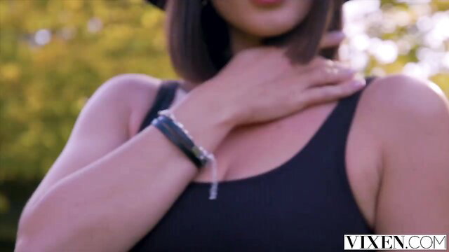 Gorgeous influencer Eve seduces fan, hand on neck in black tank top