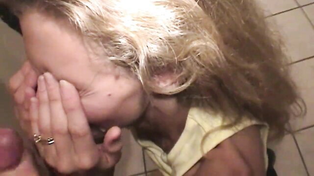 Blonde housewife covers face as man cums on her cheek in swingers gangbang