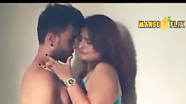 Indian couple intimate embrace, shirtless man kissing busty brunette girlfriend