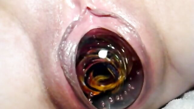 Extreme closeup of gaping pussy with colorful anal beads insertion