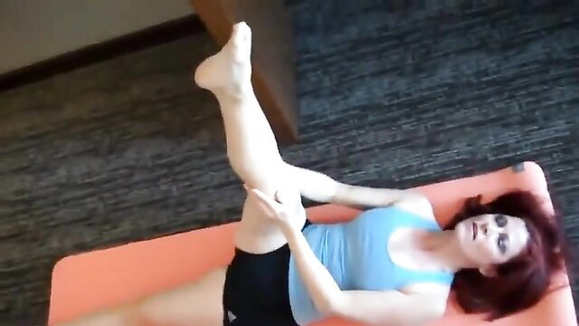 Redhead MILF stretches leg high in tight yoga shorts on mat