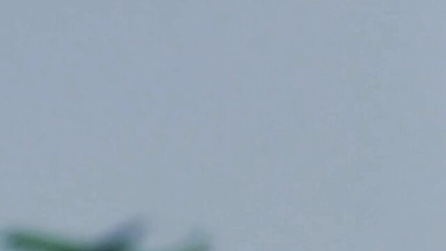 Woman in tight dress uses remote vibrator on public park walk to orgasm