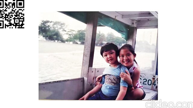 Cute Singaporean Asian boy and girl kids smiling on boat ride