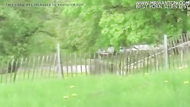 Outdoor public exhibitionist Monica fucked by fence in green field