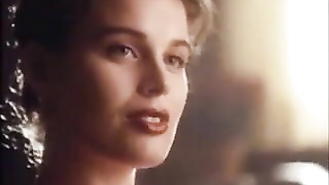 Brunette bombshell with red lips in sultry close-up gaze, 90s erotic vibe