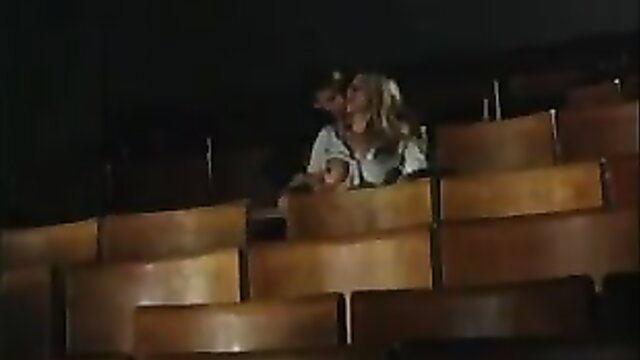 Selen au cinema: Blonde Selen in sexy blouse in theater seats