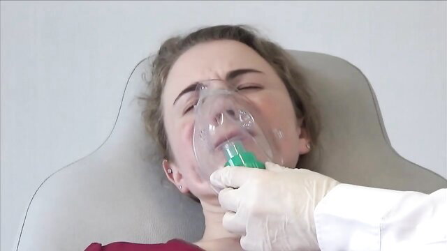 Tini anesthetized in medical mask, gloved hand BDSM therapy