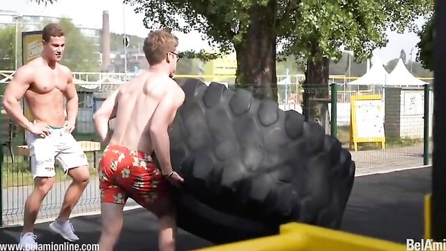 Blake Mitchell and Yannis Paluan flipping tire outdoors in speedos