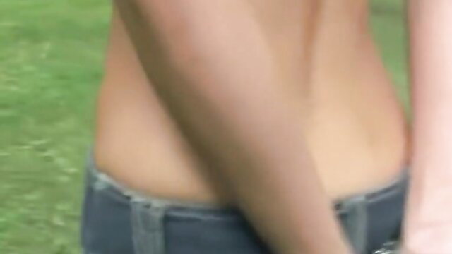 Slim topless babe in low jeans poses back view in park BDSM bondage