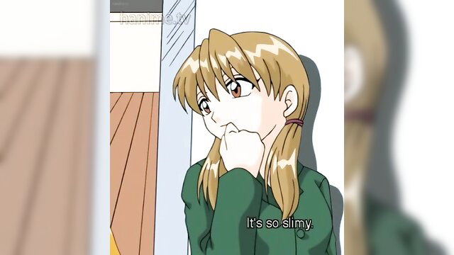 Blonde anime girl in green sweater grimacing at slimy hentai mess