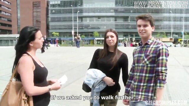 Brunette big tits MILF chats with young couple outdoors on plaza