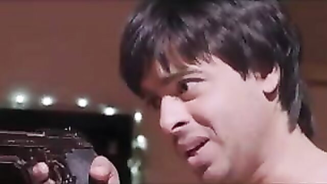 Shirtless Indian man holding gun in desi wife web series sex scene