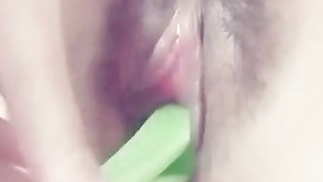 Closeup amateur pussy spread wide open with green toy insertion