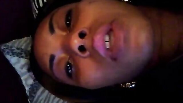 Closeup POV of sexy black woman's face with grills smirking