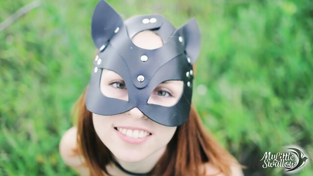 Redhead in cat mask smiles playfully outdoors, slutty wild cat tease