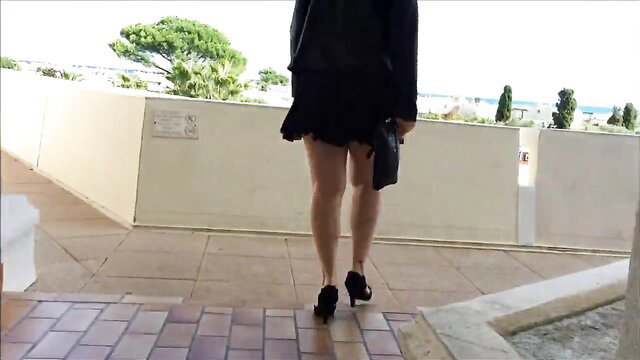 Hot wife in skimpy see-through black mini dress and heels on balcony