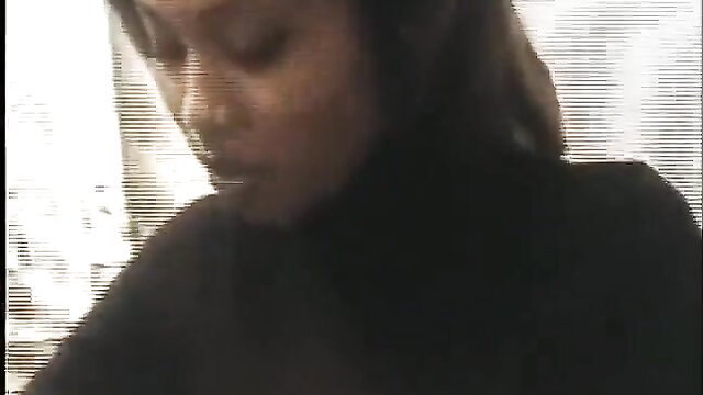 Anya closeup face ebony beauty in turtleneck, sultry gaze