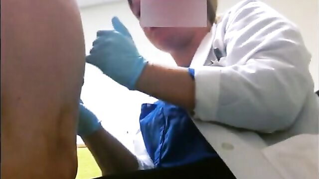 Real female doctor in white coat giving cock exam injection to male patient