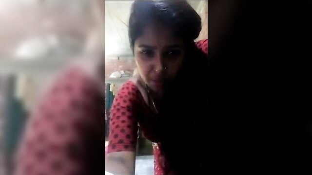 Closeup Telugu Indian woman in red polka dot saree blouse, intense gaze