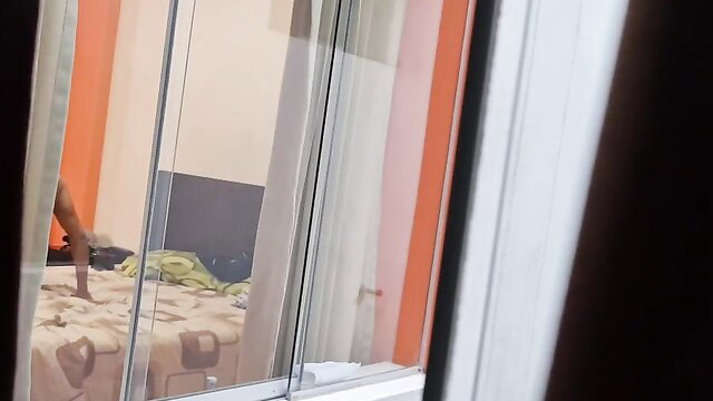 Voyeur view of nude woman cheating on hubby from hotel window