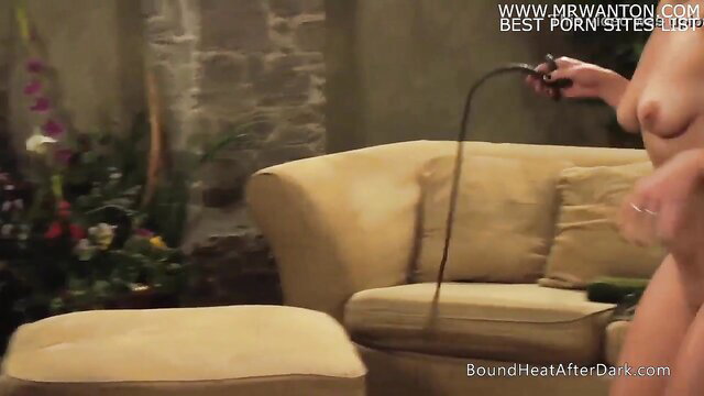 Nude busty woman teasing with whip in BDSM scene