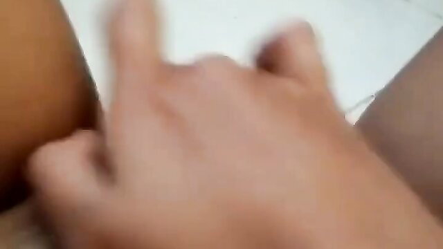 Closeup of brown-skinned hand spreading wet pussy lips in solo tease