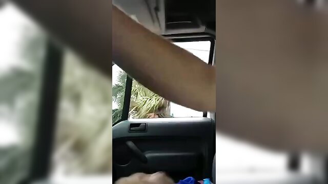 Blurry POV amateur video of arm reaching into car window with palm tree view