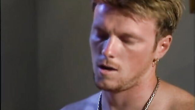 Hot blond guy with earring smirking shirtless in steamy amateur fuck video