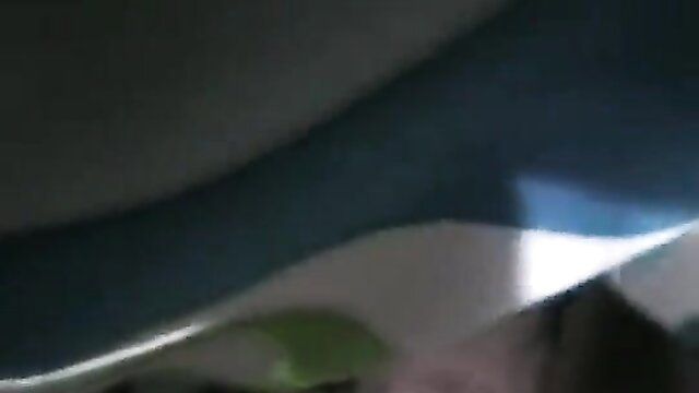 Blurry closeup of nude woman bending over in dim light