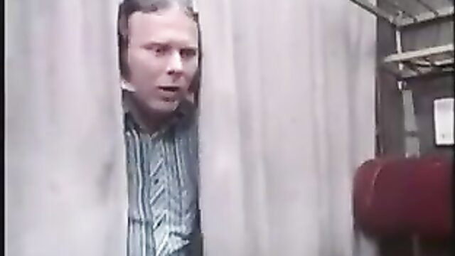 Man peeking from shower curtain in steamy adult scene