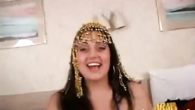 Arab BBW smiling in gold beads headpiece and sexy outfit