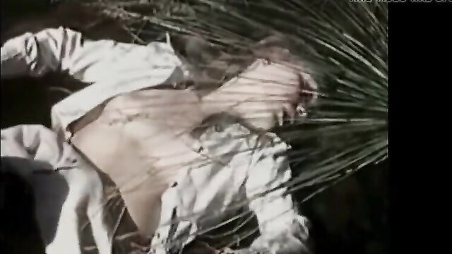 Slim Asian woman in white shirt lying topless in grass, Mr. Bigcock scene