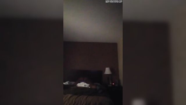 Amateur girl humps pillow with vibrator in dim bedroom