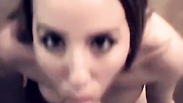 Closeup of cute brunette girlfriend's intense eyes during oral tease