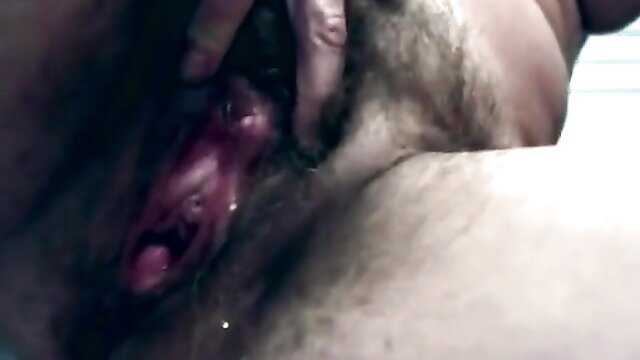 Closeup of hairy man fingering wet gaping pussy in explicit vid
