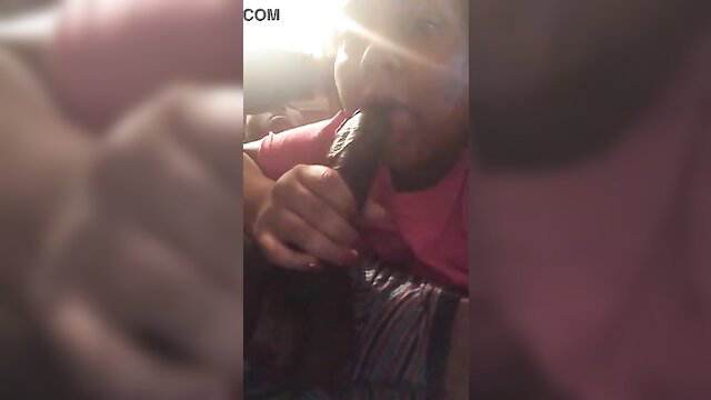 Amateur woman eagerly sucking thick black dildo closeup