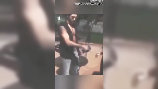 Bearded Arab man in tank top holds cock outdoor amateur tease