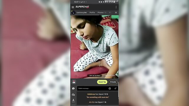 Indian girl in polka dot pajamas sits smiling on bed in sexy home video thumbnail