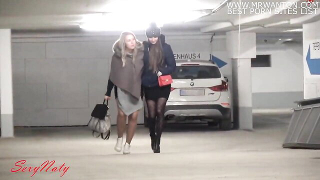Sexy Naty in sexy dress and heels walks in garage parking