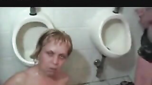 Blonde woman naked at urinals in extreme pee fetish scene