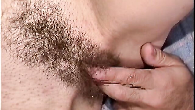 Hairy chest guy grips woman's neck passionately in bed