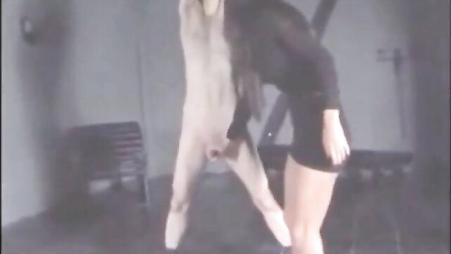 Femdom babe hoists nude male by balls in CBT torture