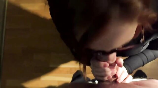 Brunette beauty on knees giving messy blowjob closeup