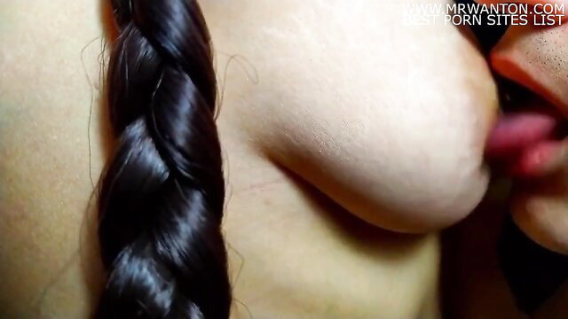 Asian beauty with braids gets juicy nipple sucked by man closeup