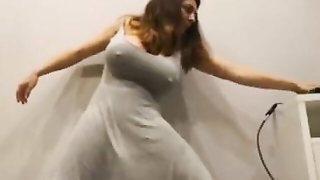 Brunette with huge tits in tight gray tank dress, arms outstretched seductively