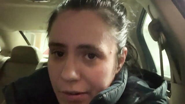 Brunette amateur in car, aroused expression, puffy jacket and ponytail