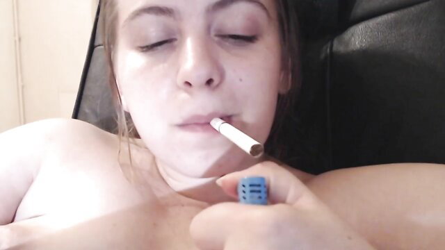 Nude white girl with brown hair smoking cigarette topless closeup