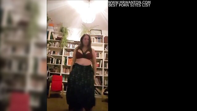 Brunette MILF stripping in bra and skirt solo tease