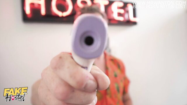 Fake Hostel manager holds thermometer gun at two hot nurses in hotel